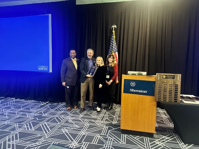 Vernon Jackson, NSPMA Awards Chairman and Kim Keener, Awards Committee, presenting First NSPMA Pioneer Award to Debbie and Bill Shedden.